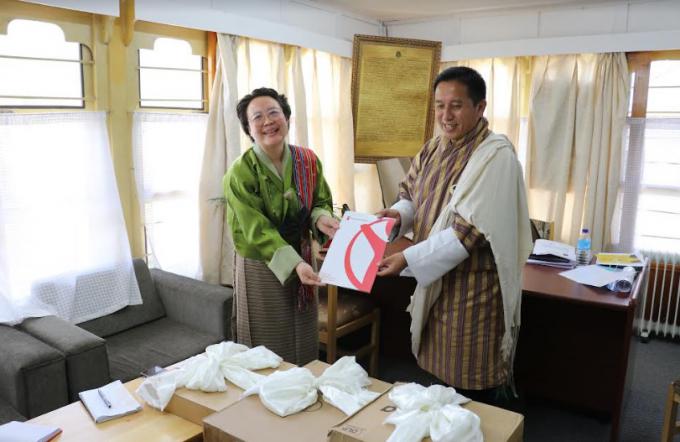 National Director of Save the Children in Bhutan, Ms. Karma Doma Tshering handing over the ICT equipment to Director General, Department of School Education, Ministry of Education, Dasho Karma Galay